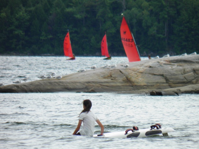 Photo: Chloe on the Windsurfer, While Steve and Hanzo are Returning, and the Other Steve Heads Out